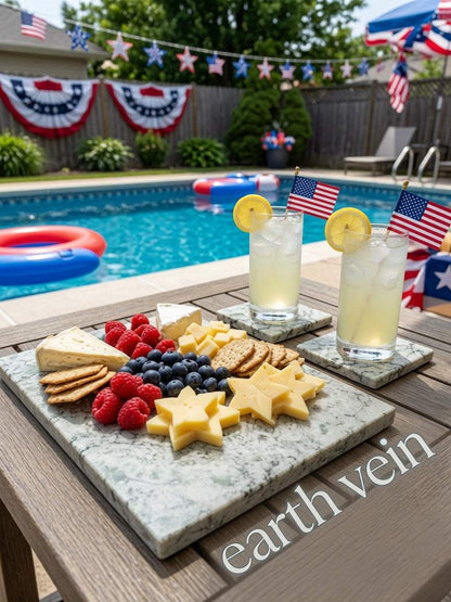 Marmo Verde green-veined quartz serving board with matching coasters, cheese, berries, crackers and cocktails